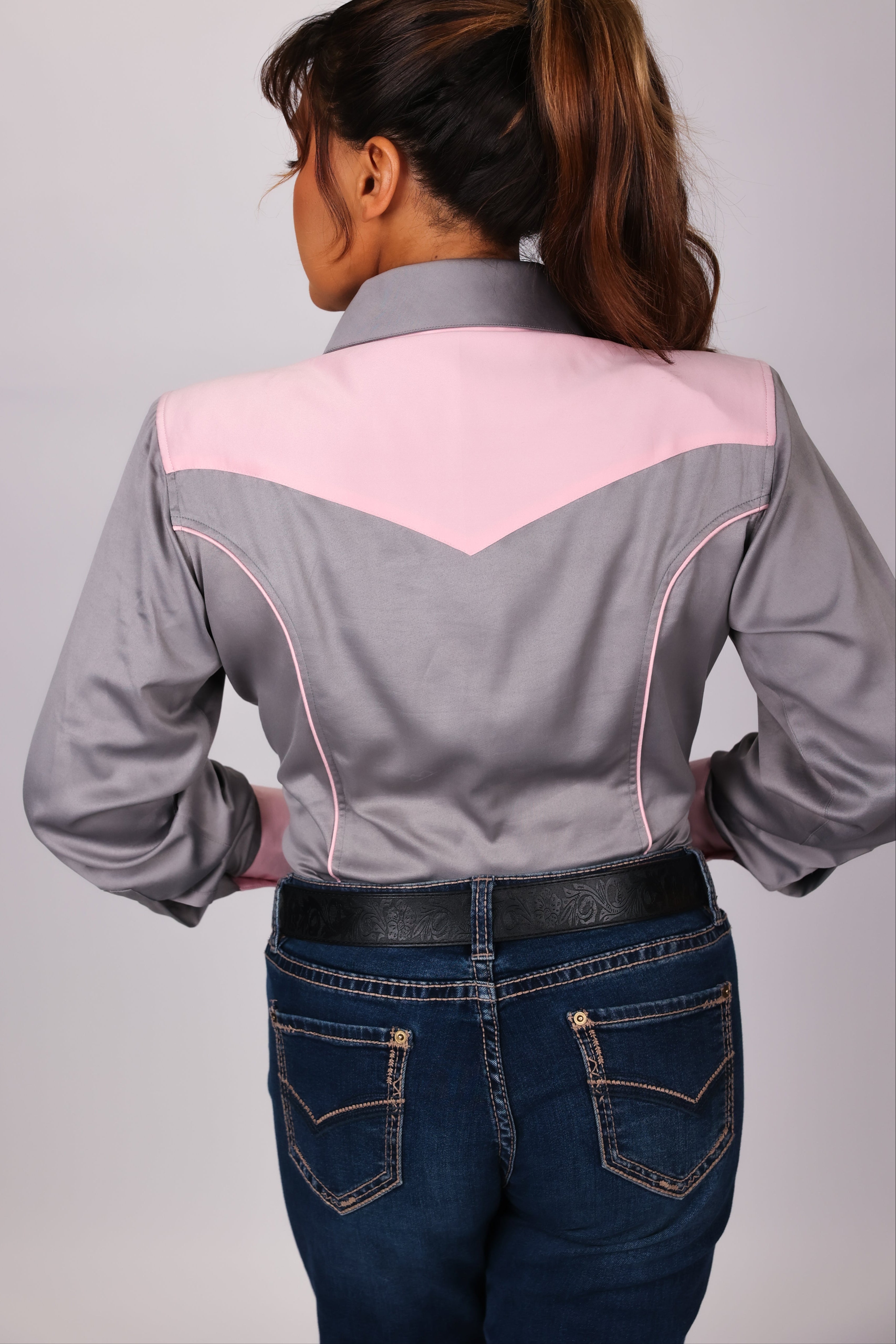 Model in studio setting posing in grey shirt from Carlee Collection by Kultured Rider