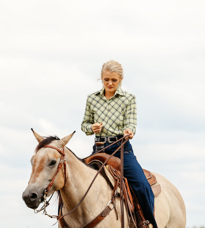 Model on horse posing in Shanena Yellow riding shirt by Kultured Rider
