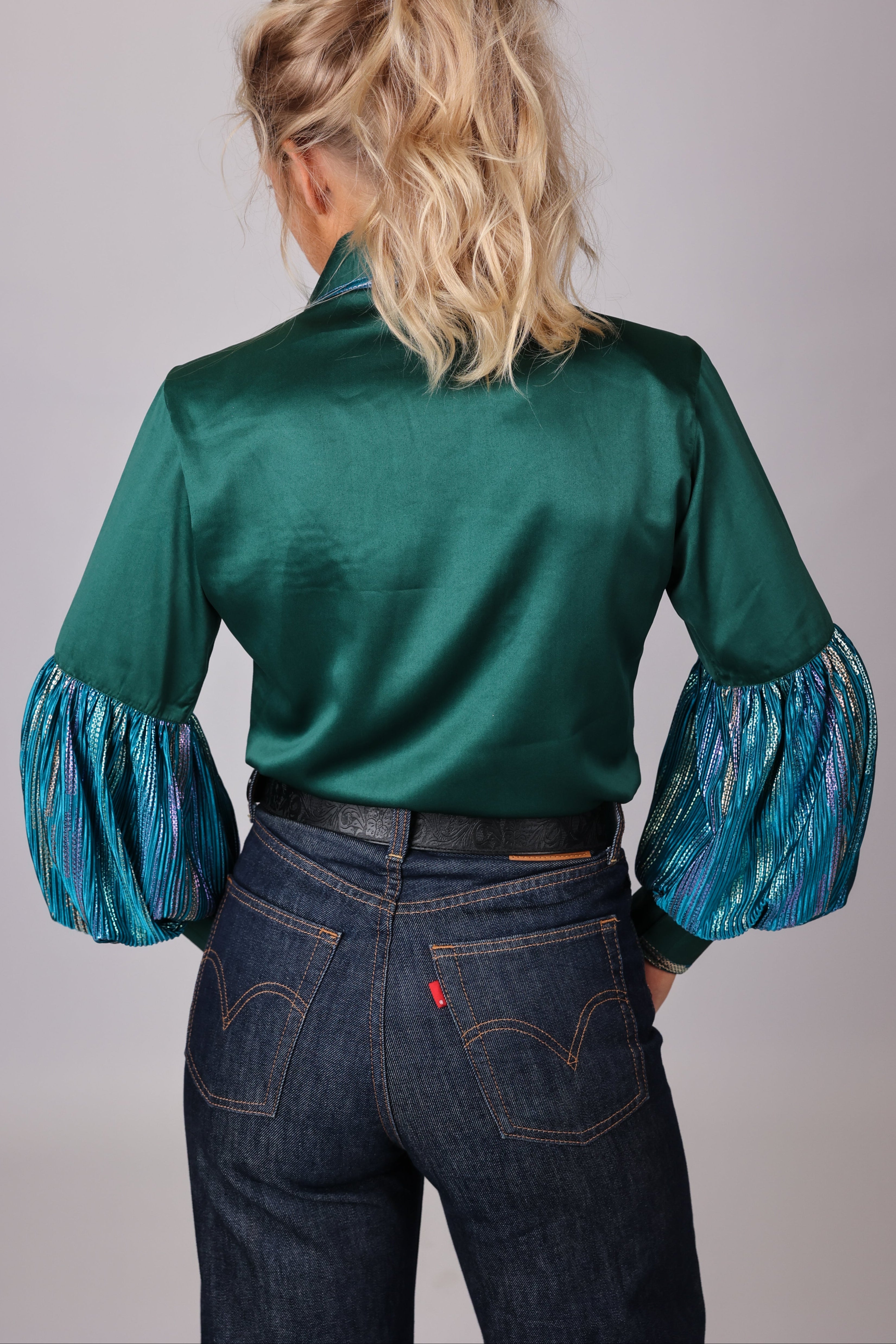 Model posing in studio setting with Spankol Green shirt by Kultured Rider