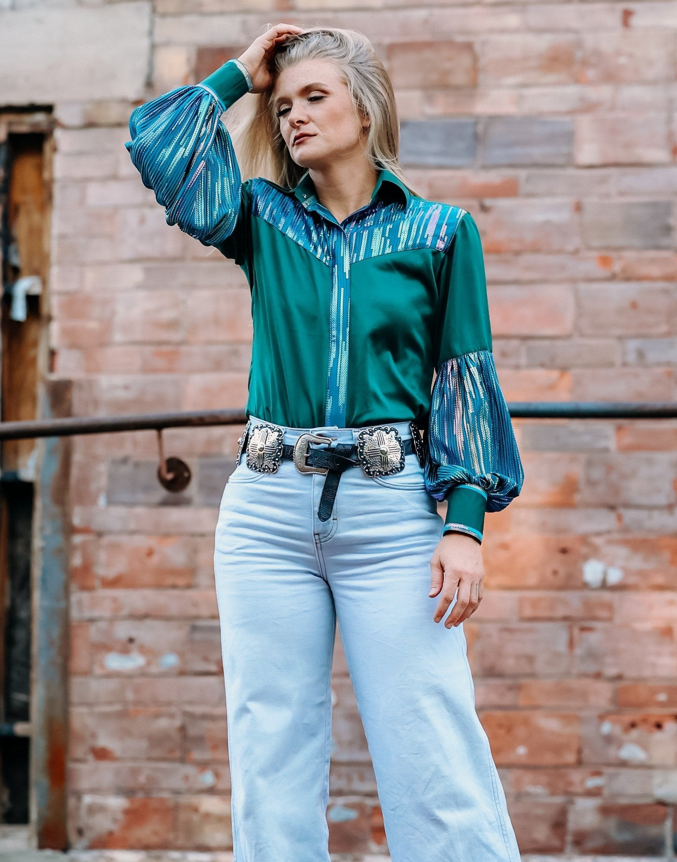 Model posing in front of brick wall with Spankol Green shirt by Kultured Rider