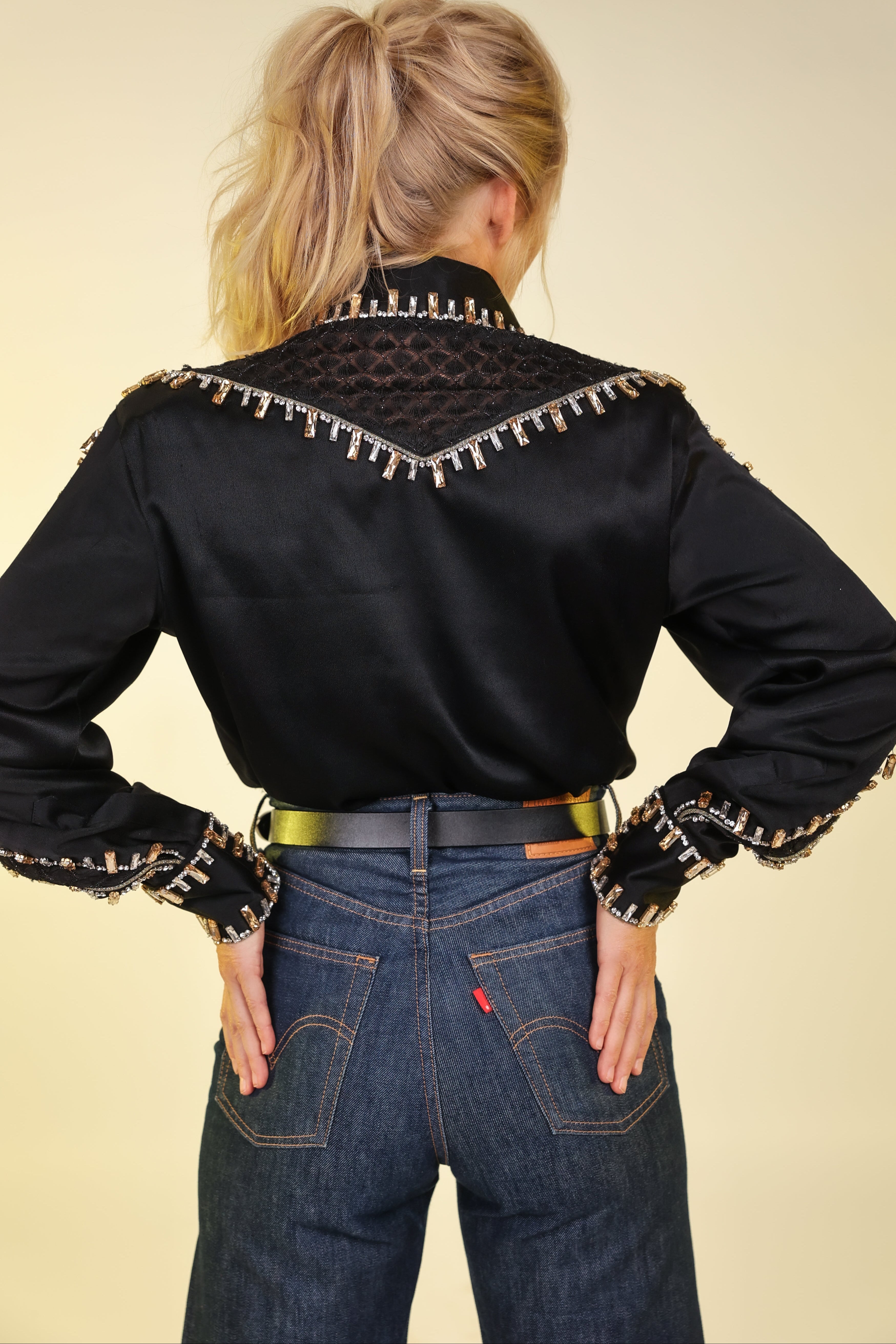 Model posing in Trinket shirt from Urban cowgirl collection by Kultured rider, displaying back details