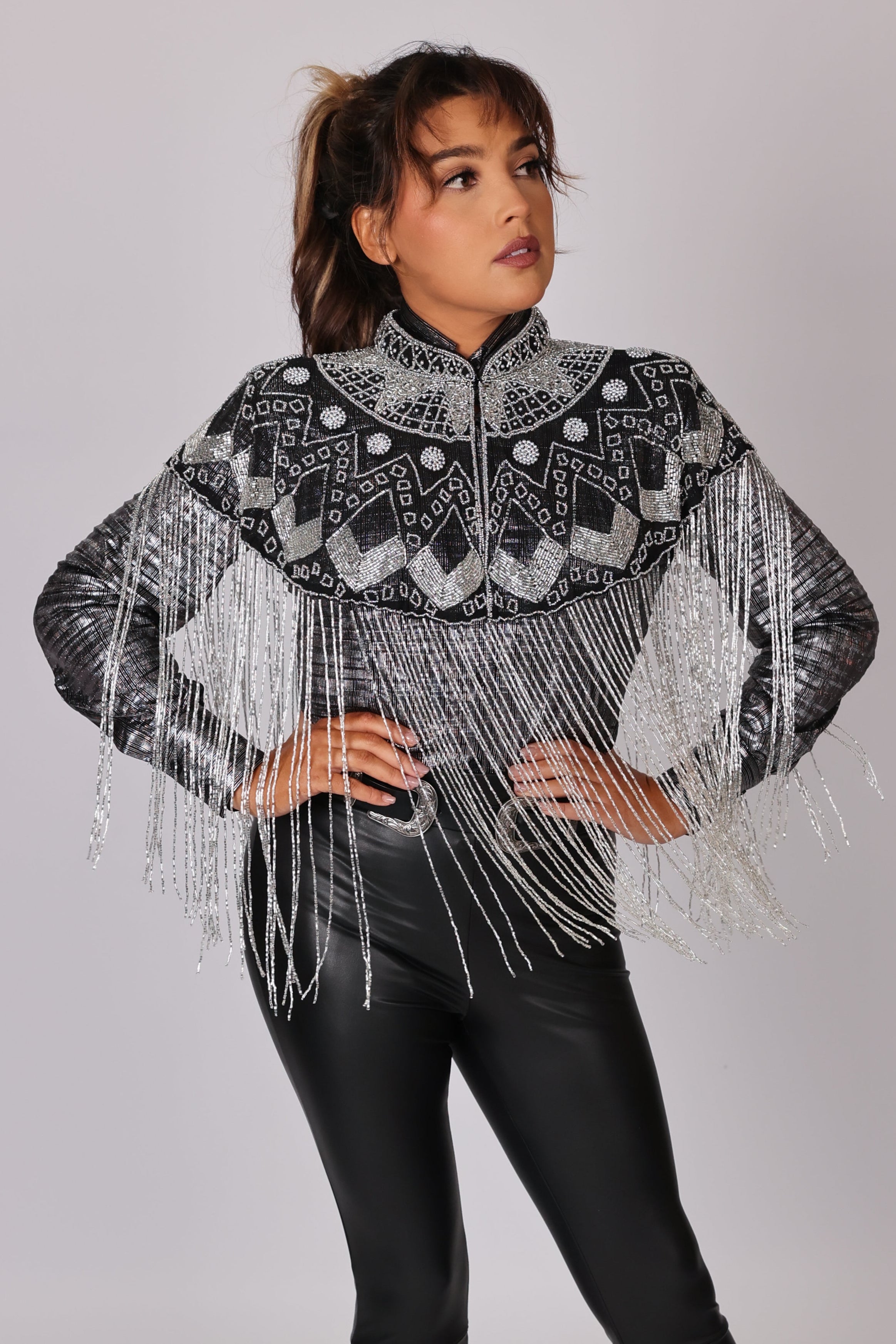 Model posing in Silver vest by Kultured rider in studio setting