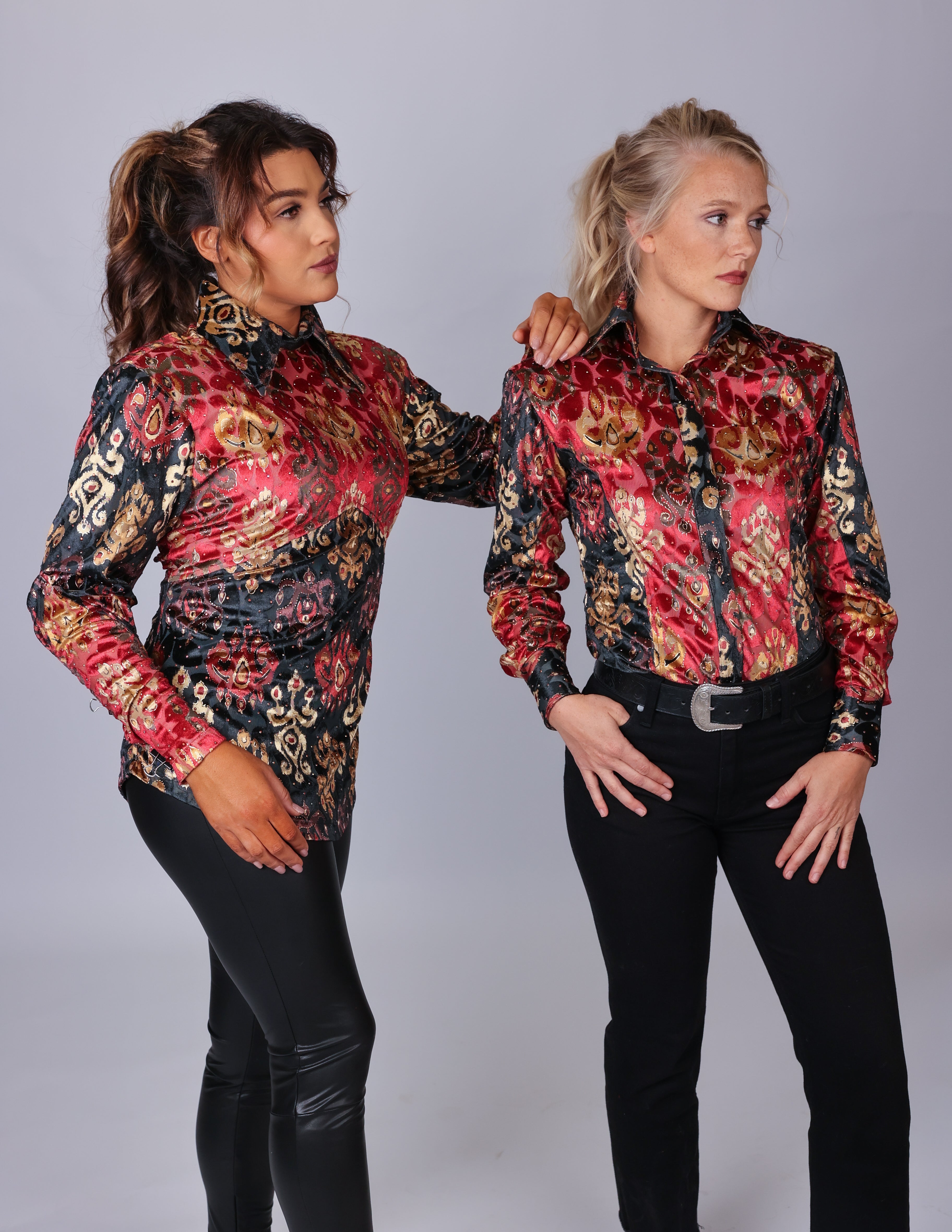 Two women in red and black velvet western performance shirts