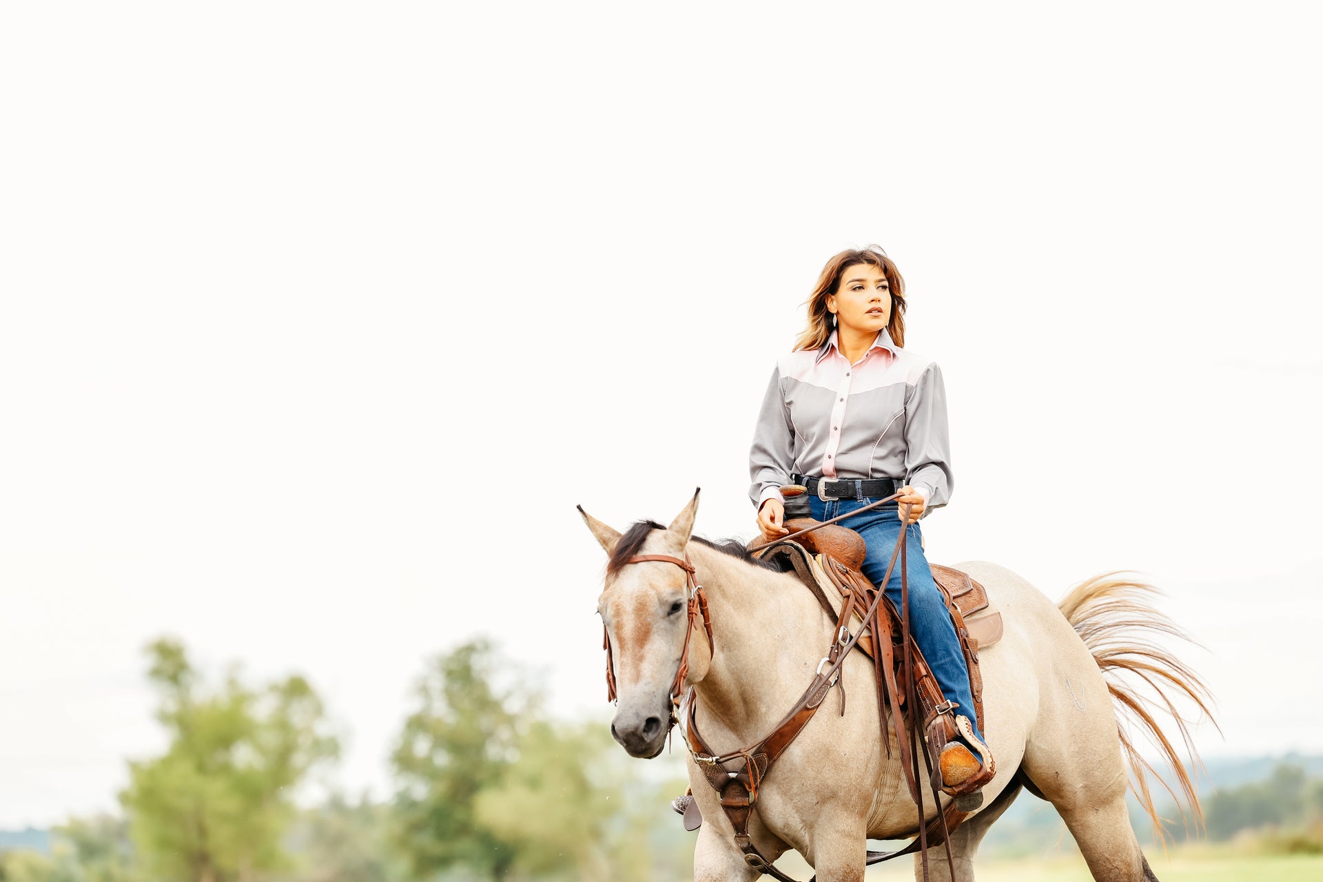 Model on horse posing in grey riding shirt from Carlee Collection by Kutlured Rider