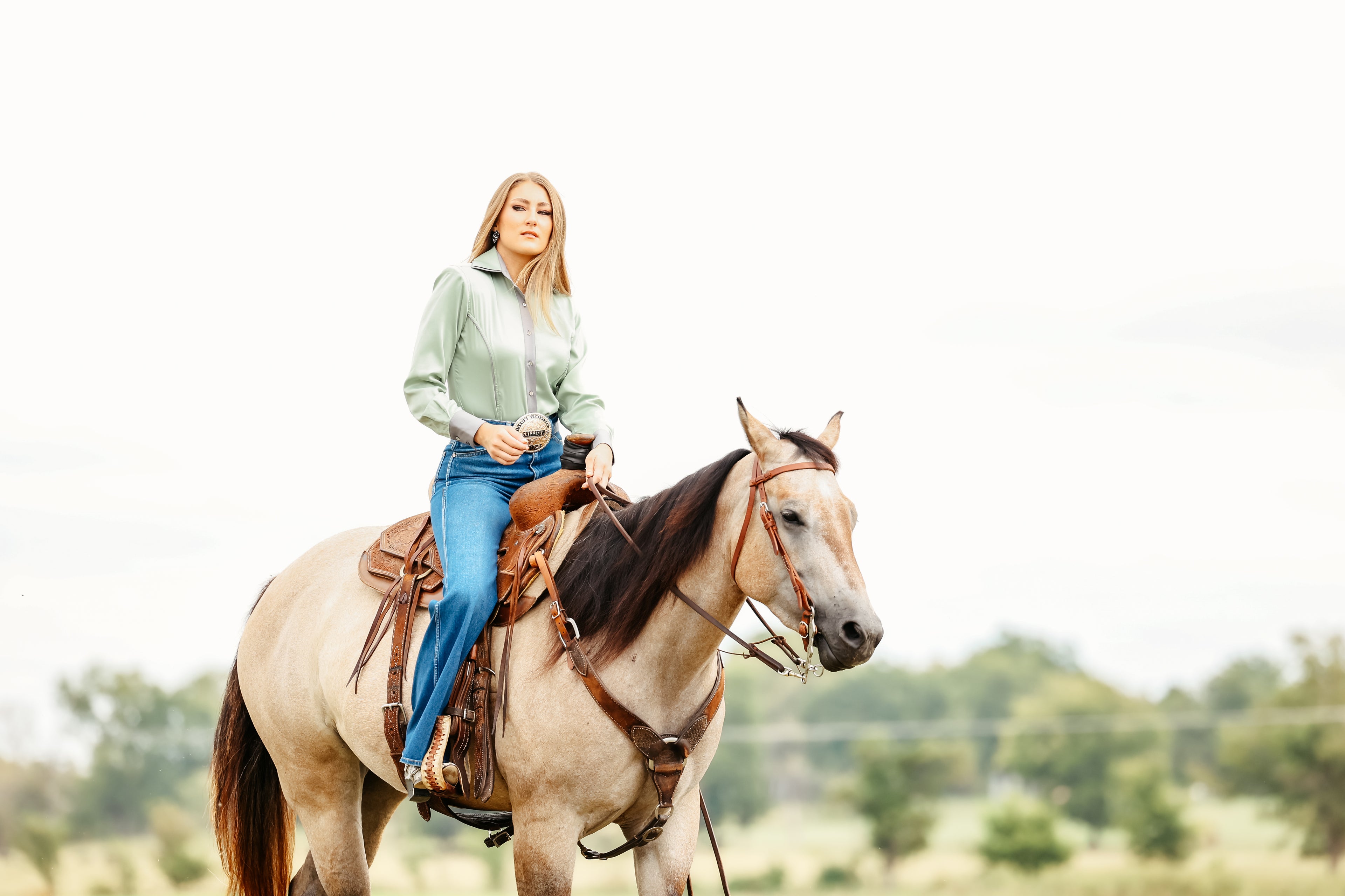 Model on horse posing in Carlee Mint Shirt by Kultured rider