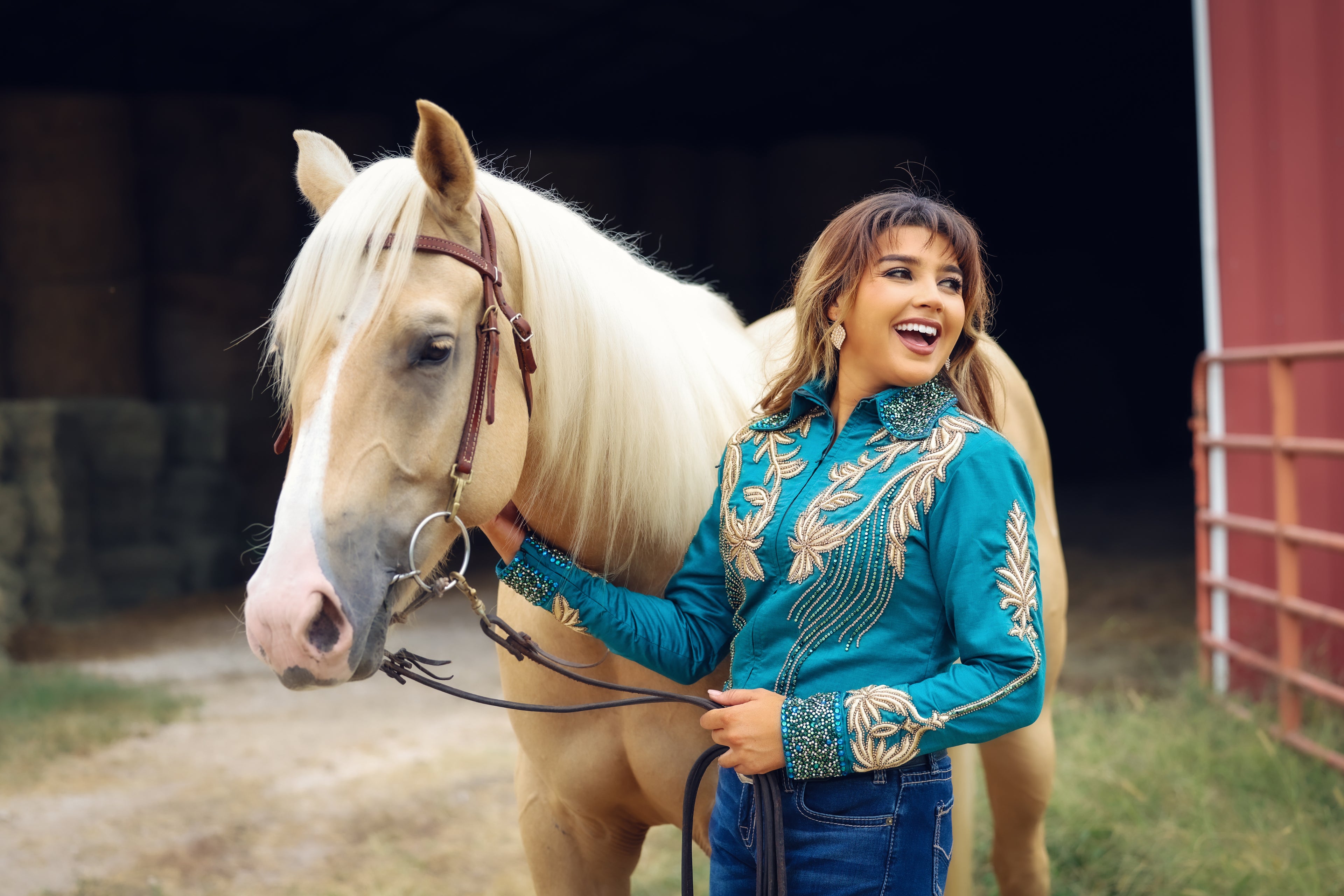 Model posing with horse in emerald and gold jacket by Kultured Rider