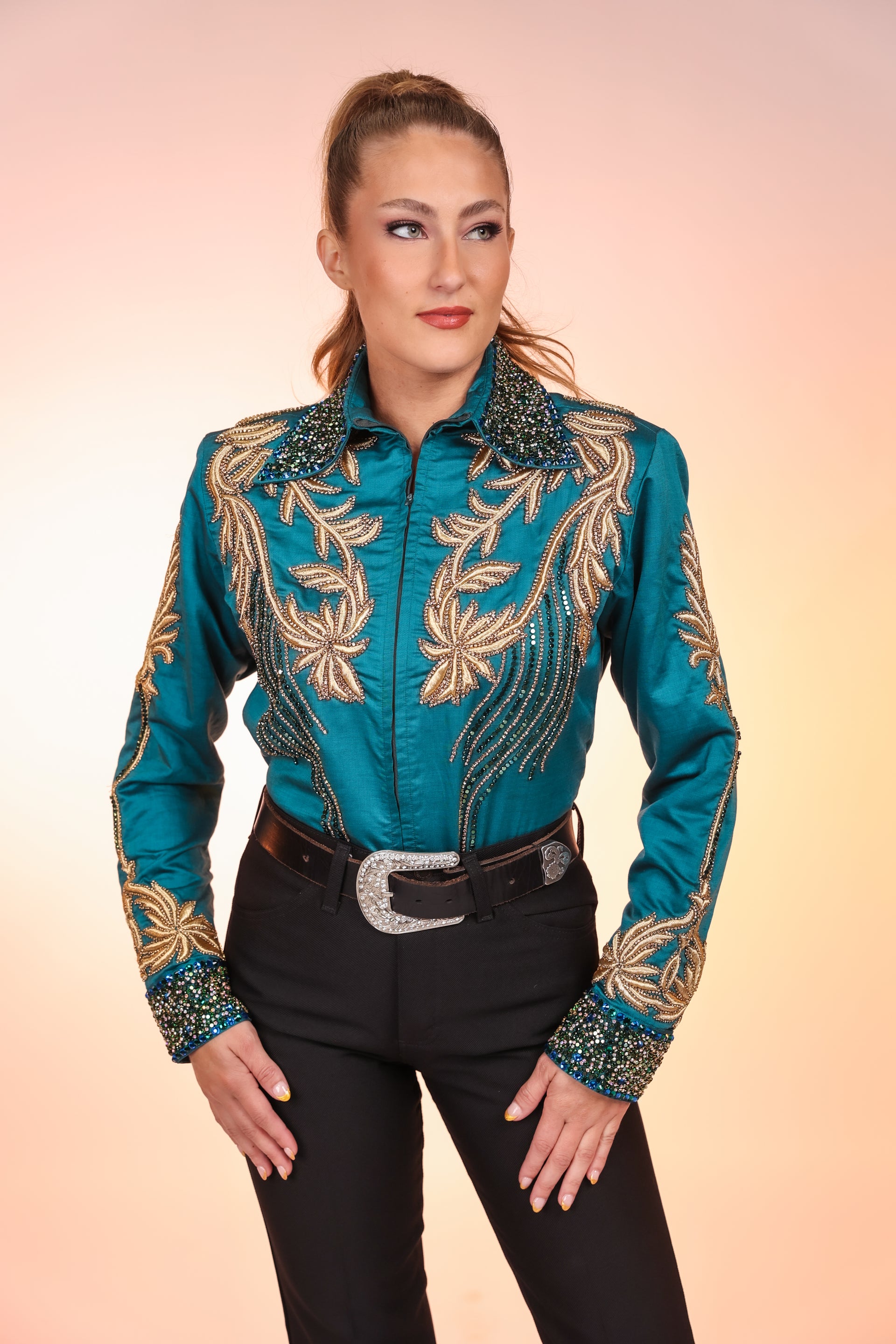 Model posing in studio with emerald and gold jacket by Kultured Rider