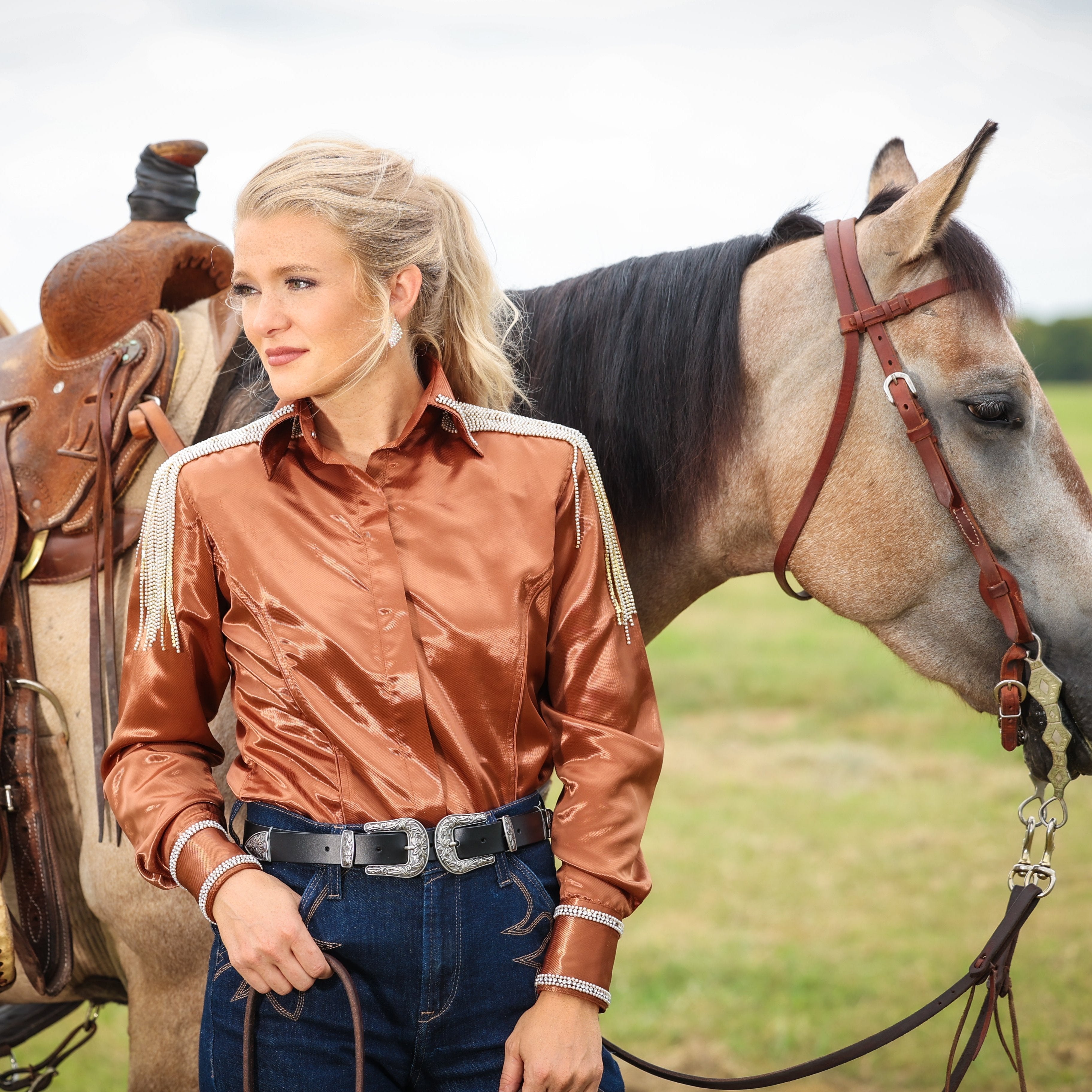 Model on horse posing in copper riding shirt from Urban Cowgirl collection by Kultured Rider