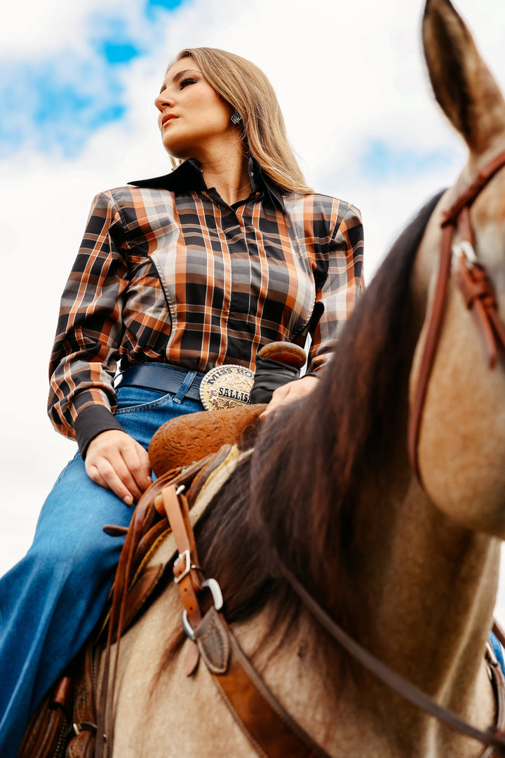 Model on horse posing in plaid brown riding shirt from the Essentials collection by Kultured Rider