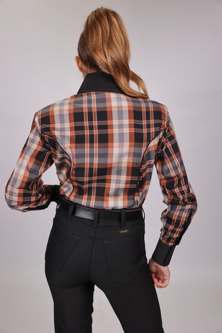 Model posing in plaid brown riding shirt from the Essentials collection by Kultured Rider, displaying the back