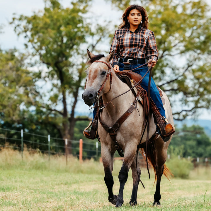 Model on horse posing in plaid brown riding shirt from the Essentials collection by Kultured Rider