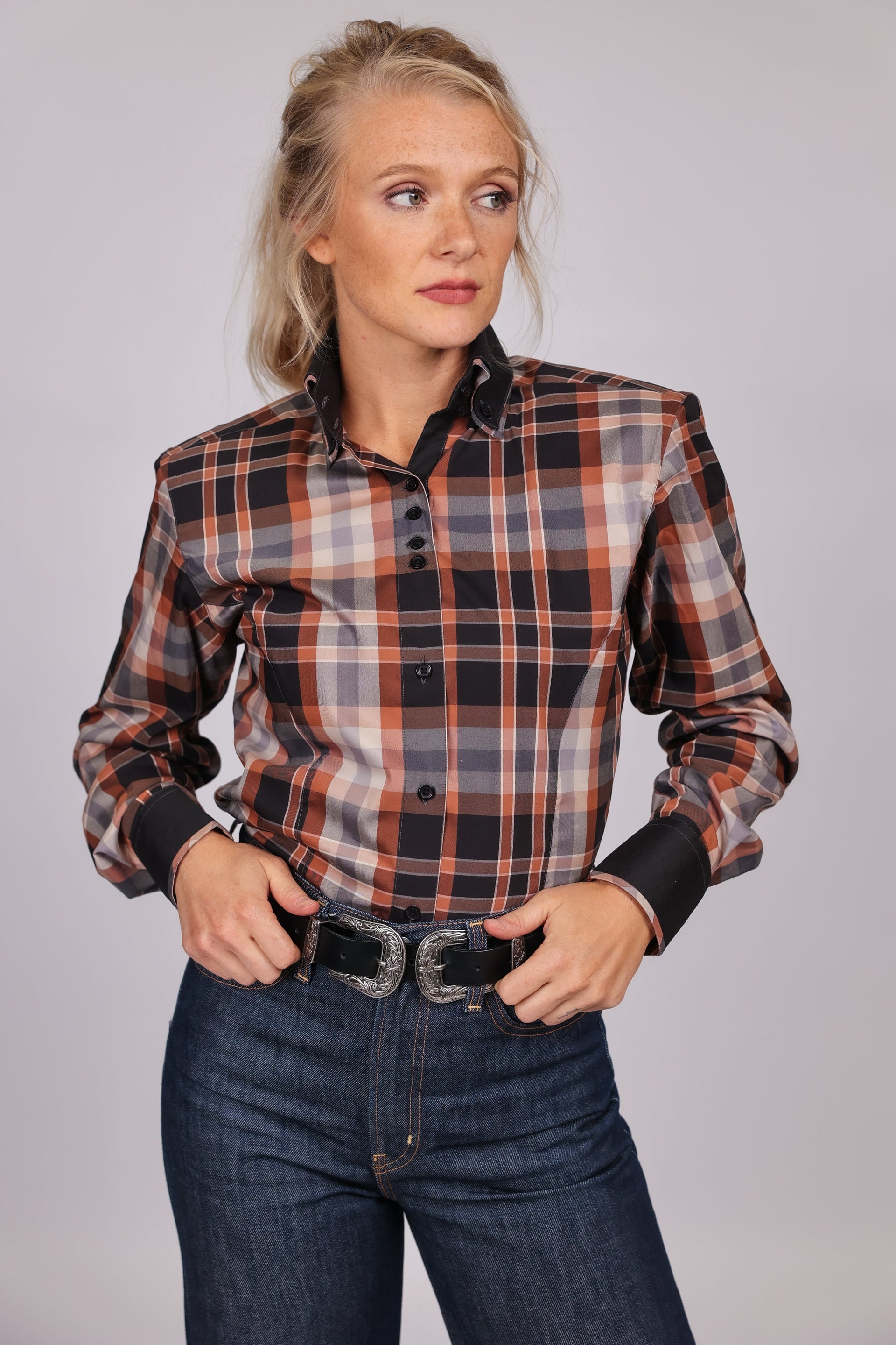 Model posing in plaid brown riding shirt from the Essentials collection by Kultured Rider