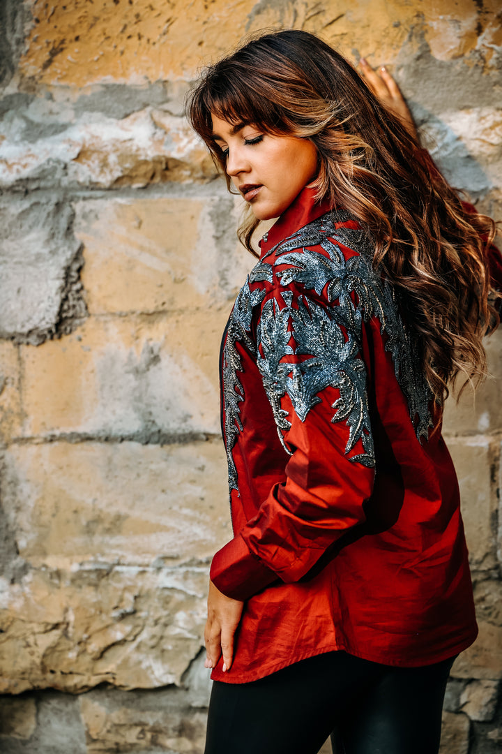 Model posing in Red Gunmetal blouse by Kultured Rider