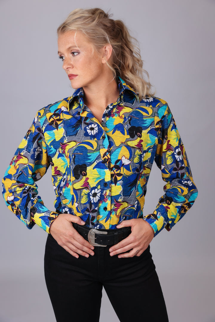 Woman posing in studio in jungle blue shirt from the Romina collection by Kultured Rider.