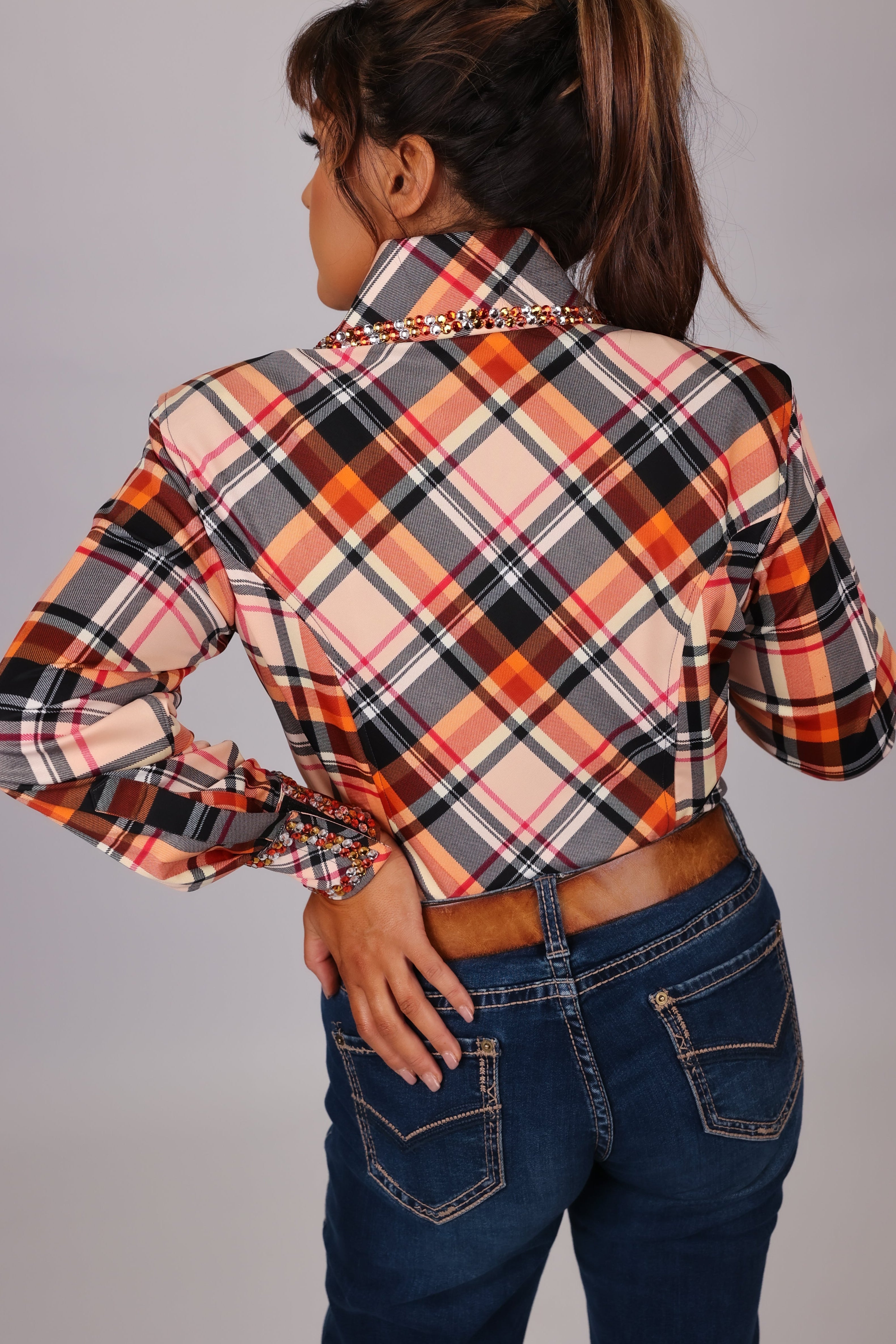 Model in studio setting posing in Orange shirt from Shanena collection by Kultured rider