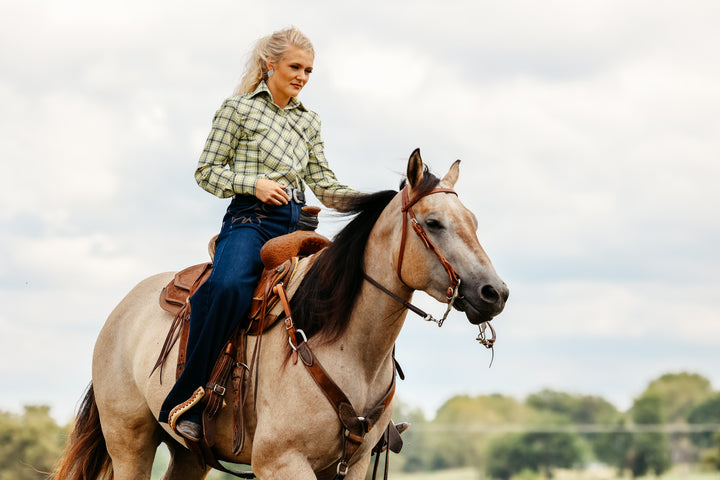 Model on horse posing in Shanena Yellow riding shirt by Kultured Rider