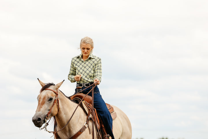 Model on horse posing in Shanena Yellow riding shirt by Kultured Rider