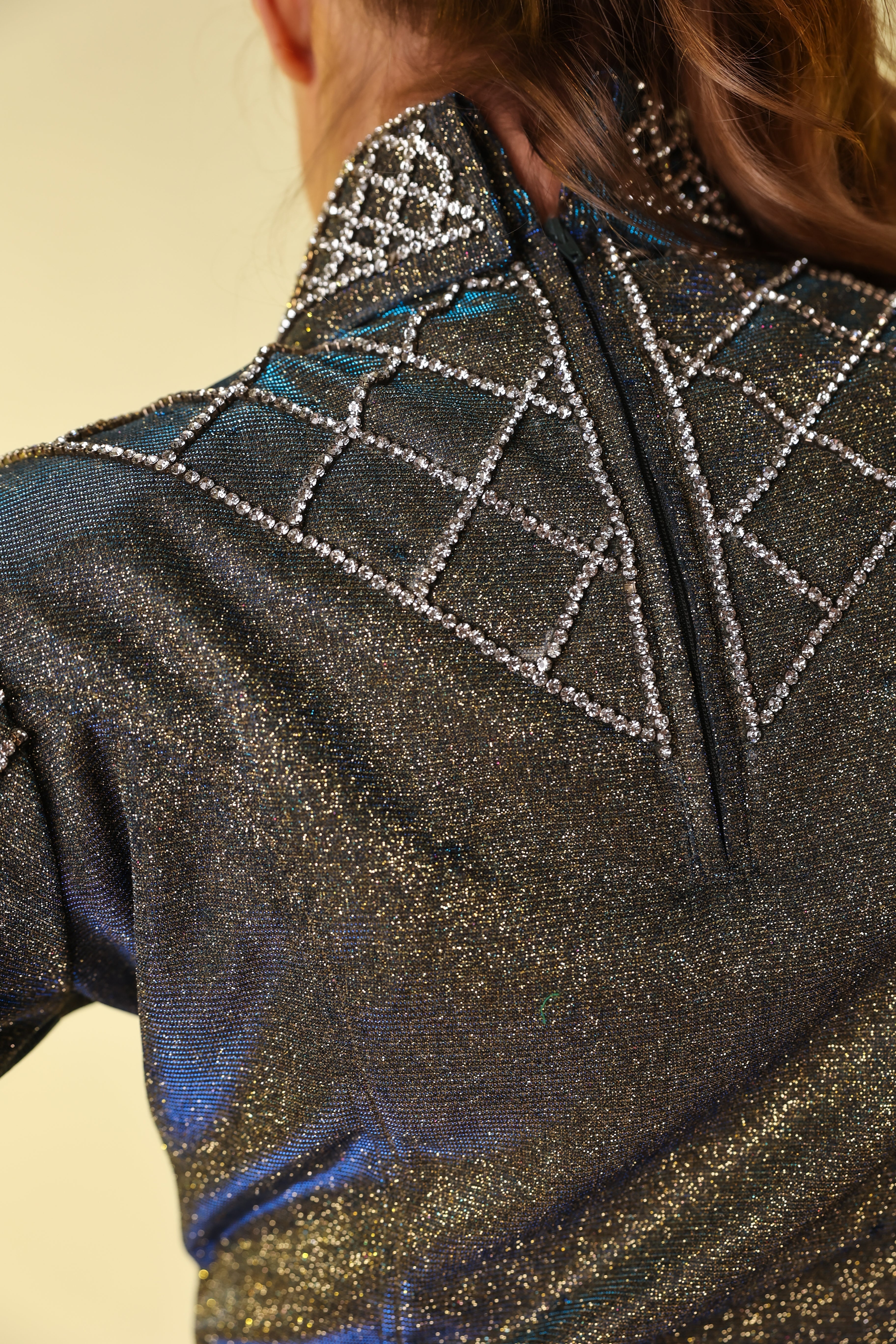 Model displaying back details of silver back zip riding shirt by Kultured Rider
