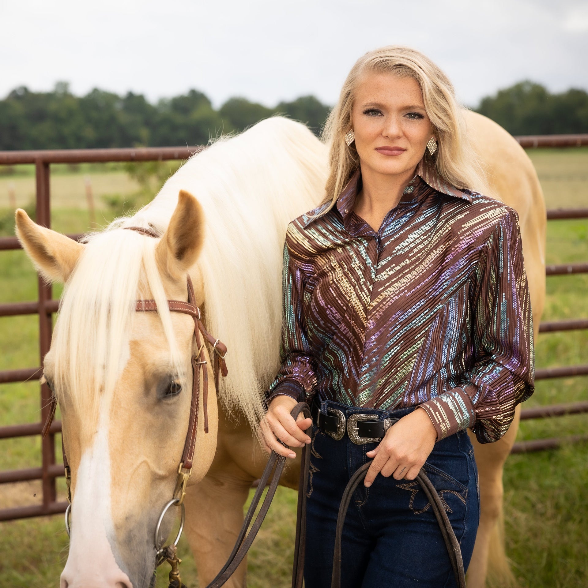 Model posing with horse in front of cattle fence with Spankol brown shirt  by Kultured Rider