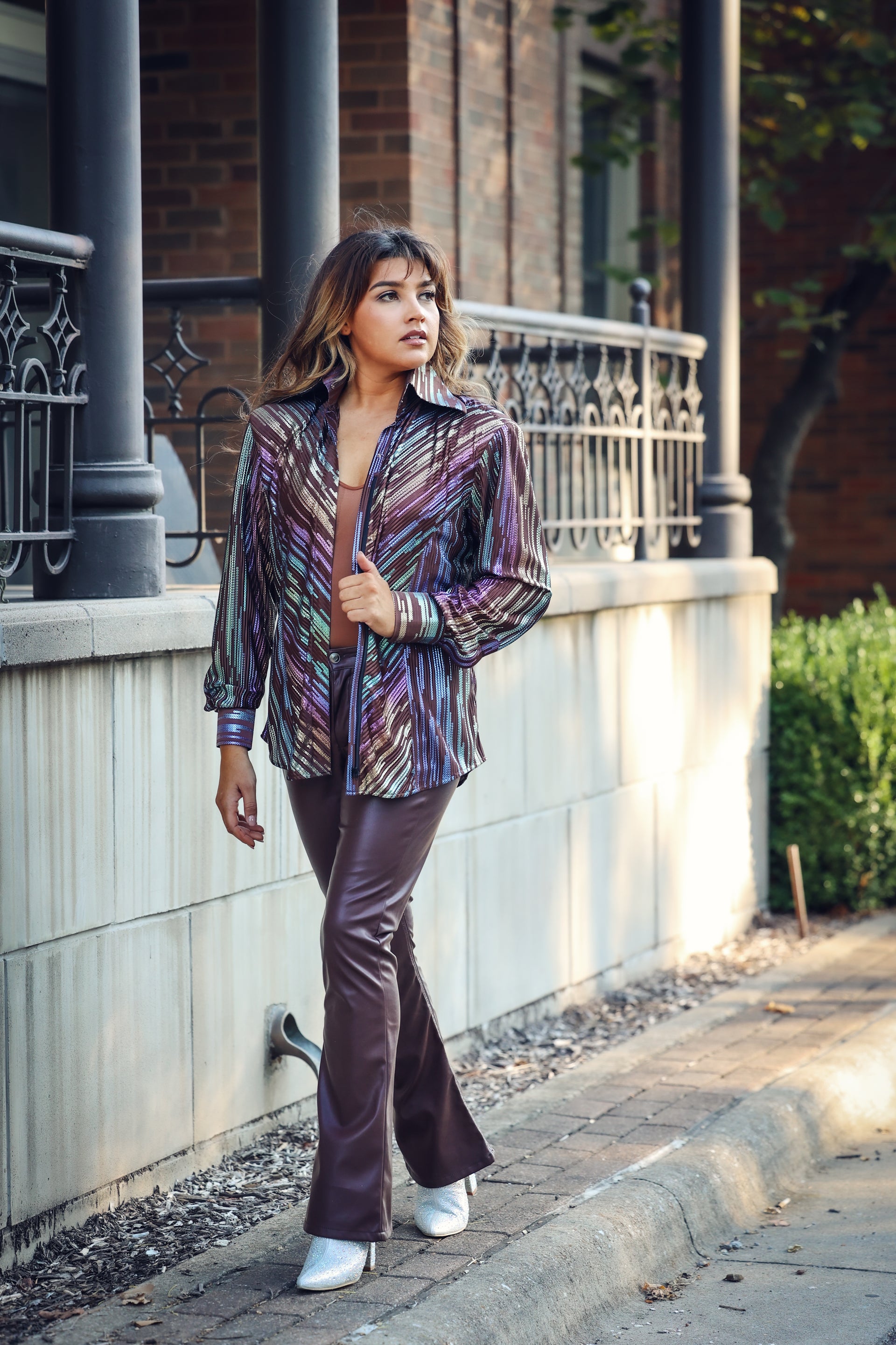 Model posing in urban setting with spankol brown shirt by Kultured rider