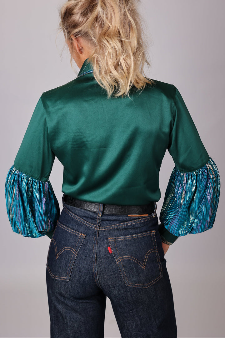 Model posing in studio setting with Spankol Green shirt by Kultured Rider