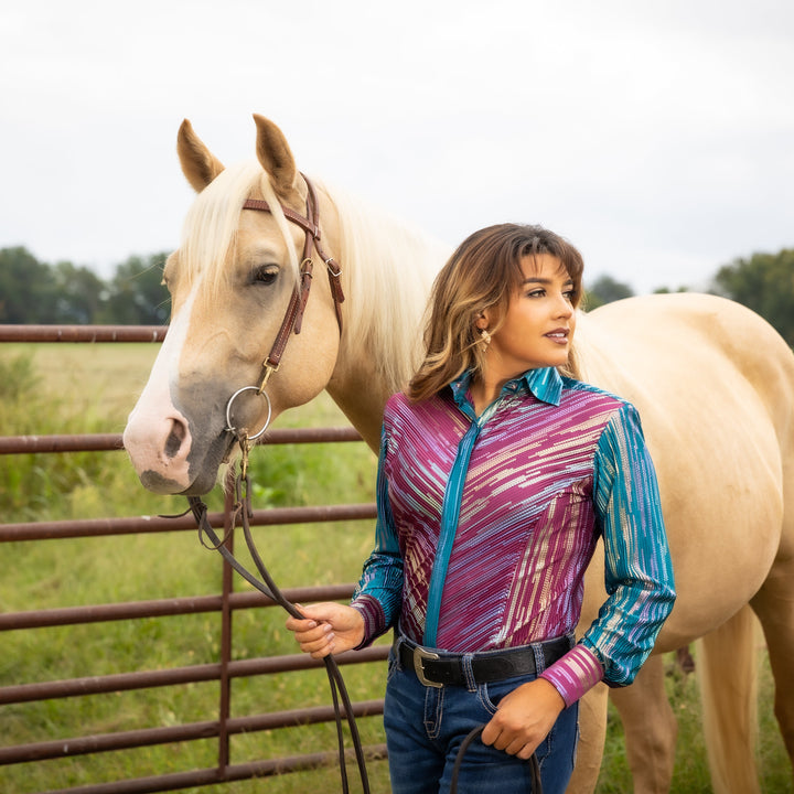 Model posing with horse in front of cattle fence with Spankol PInk & Green shirt by Kultured Rider