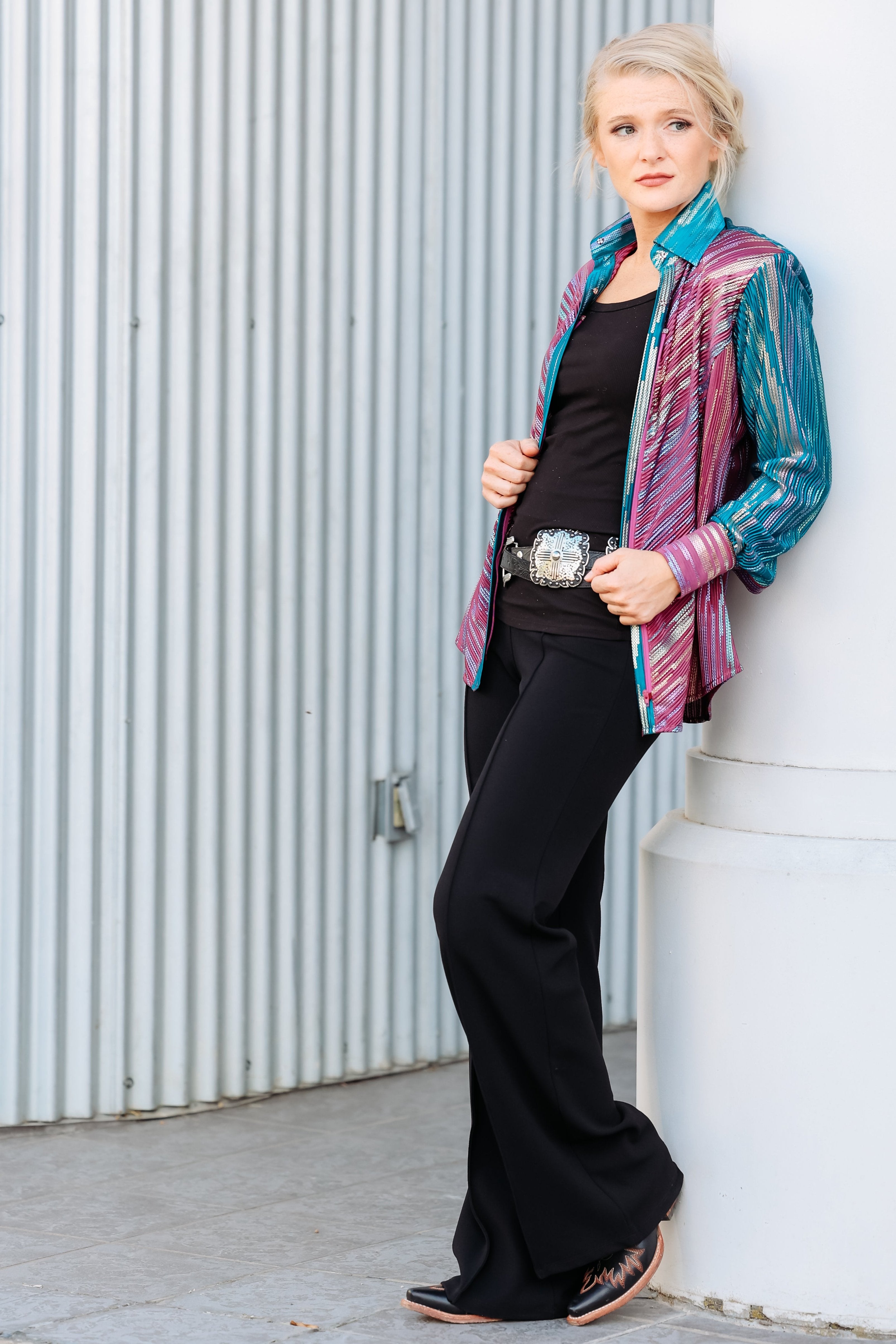 Model posing in front of urban setting with Spankol PInk & Green shirt by Kultured Rider