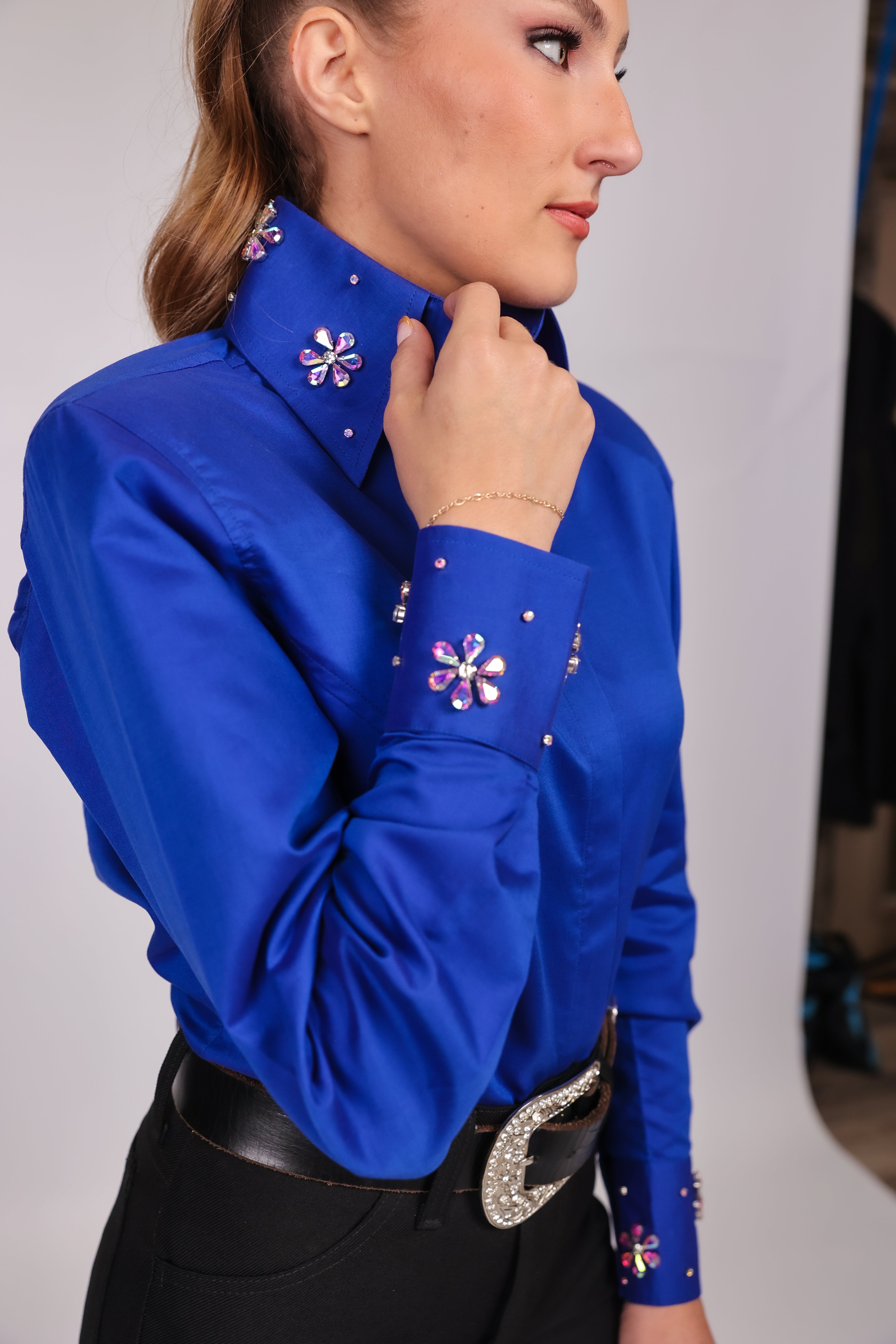 Model posing in studio setting displaying collar details from the Retro riding shirt from the urban cowgirl collection by Kultured rider