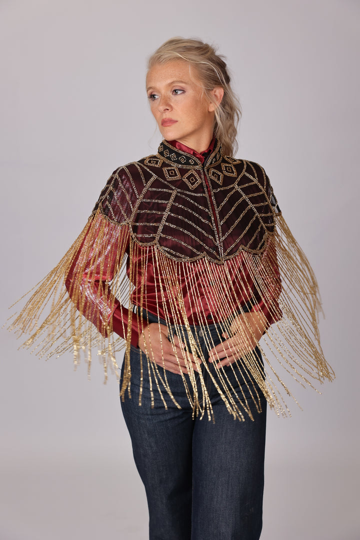 Model posing in Gold vest by Kultured rider in studio setting