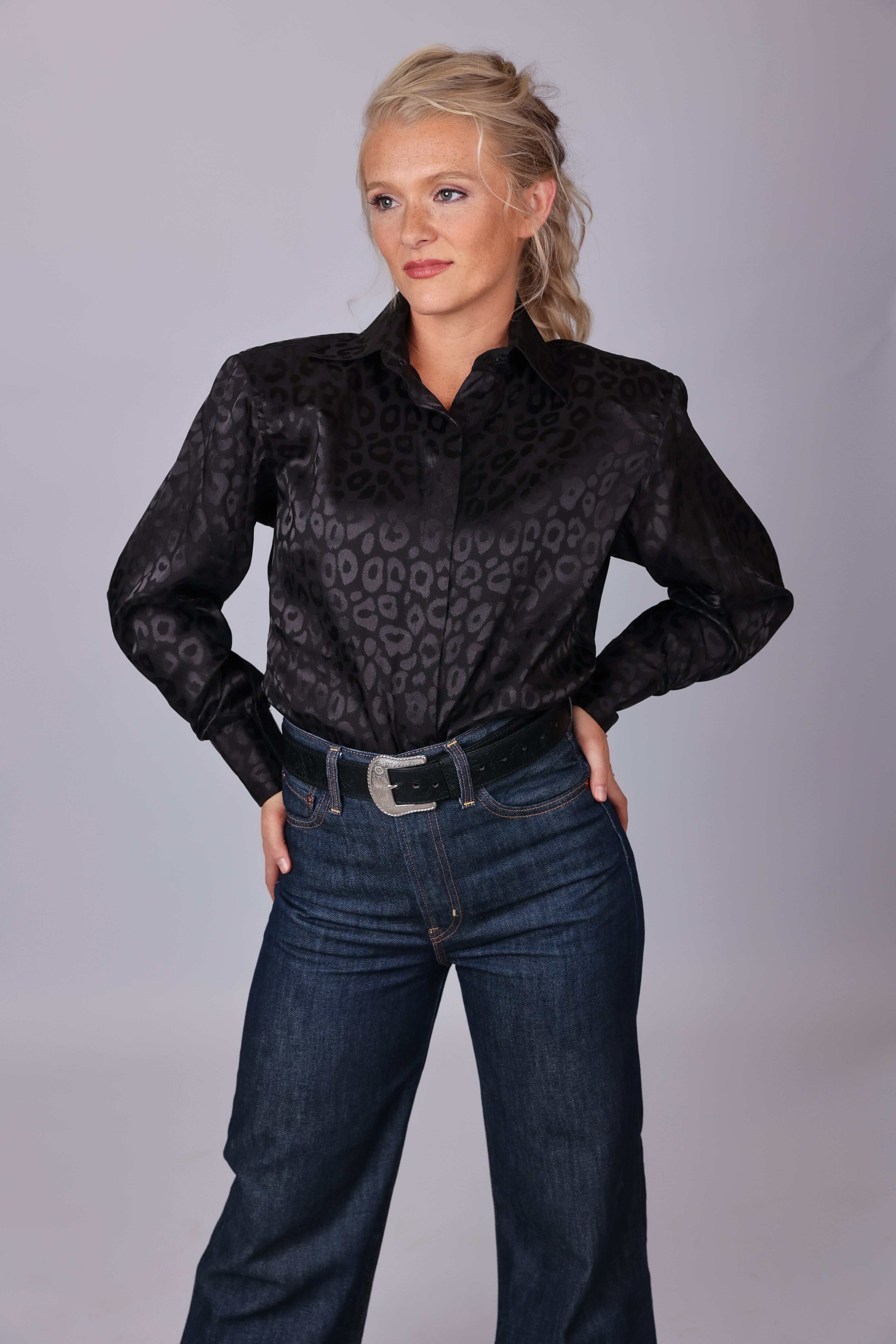 Model posing in leopard black shirt from the Faith collection by Kultured Rider in a studio setting.