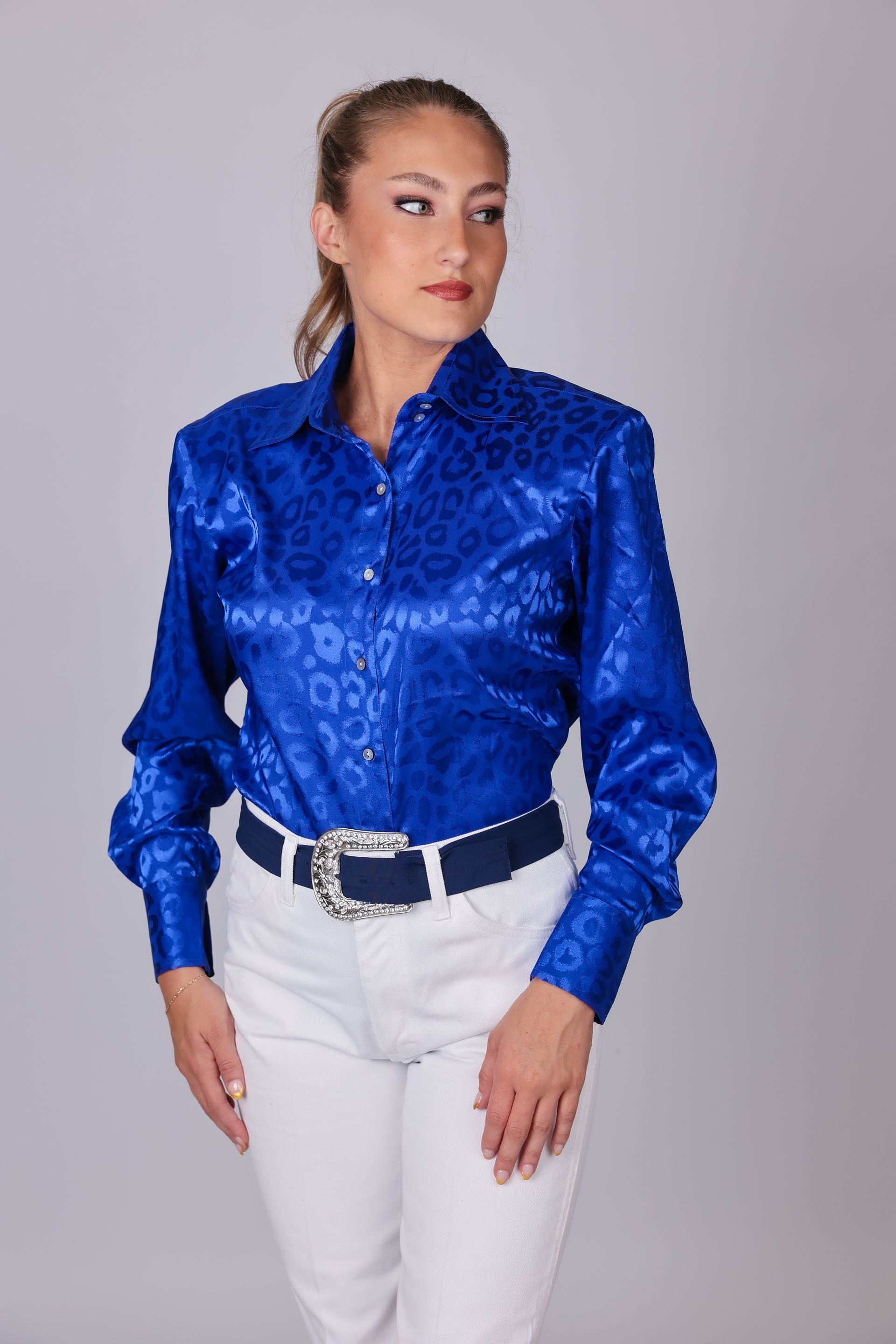 Model with horse posing in leopard blue shirt from the Faith collection by Kultured Rider in a studio setting.