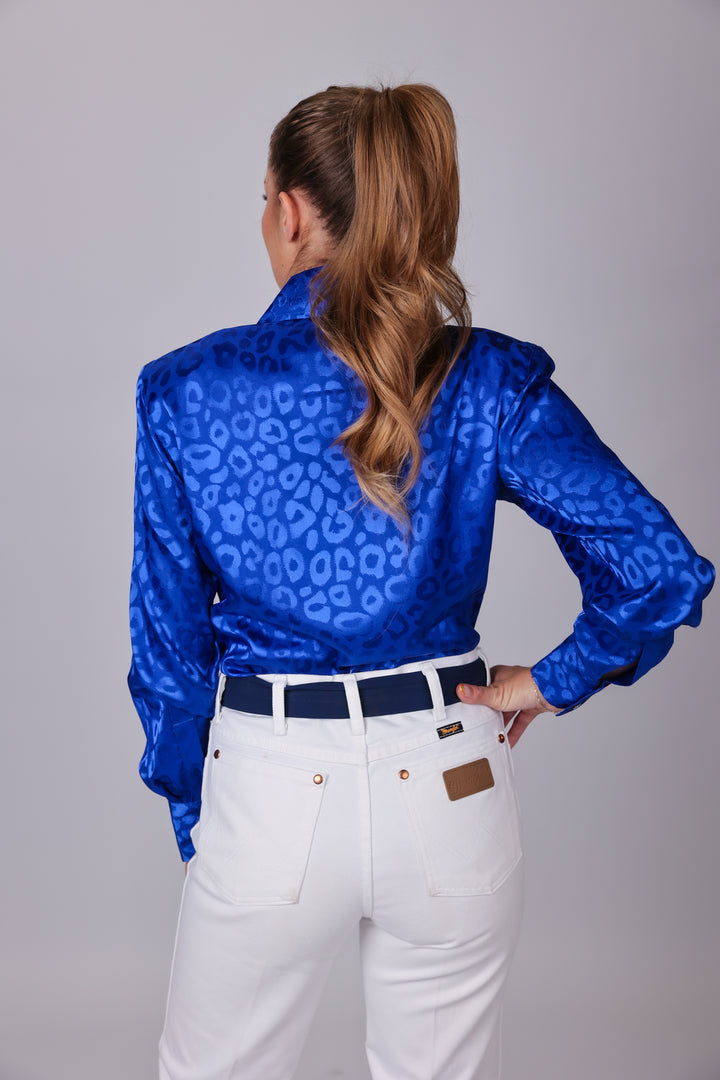 Model with horse posing in leopard blue shirt from the Faith collection by Kultured Rider in a studio setting.