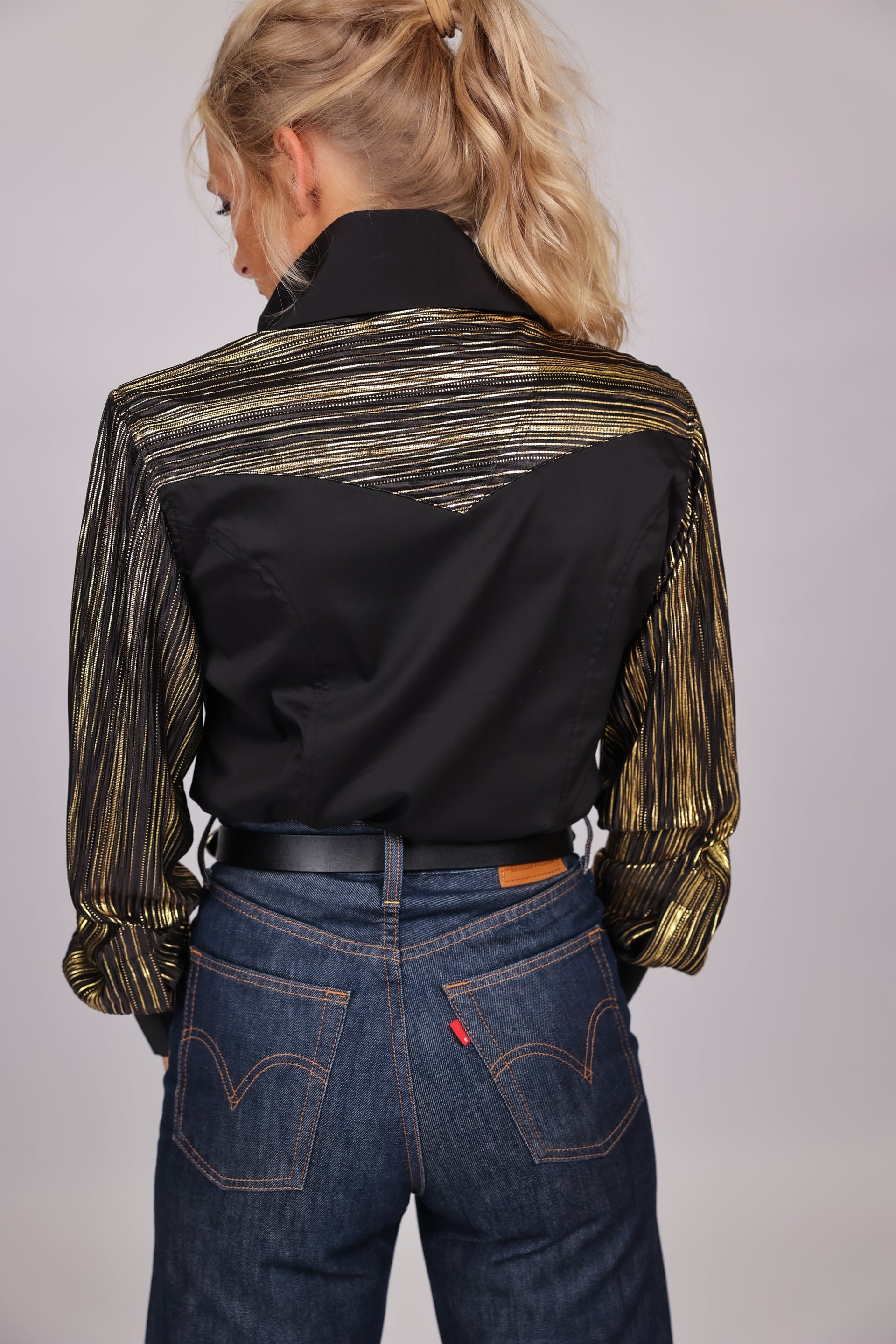 Model displaying back of Josie riding shirt from Urban cowgirl collection by Kultured Rider