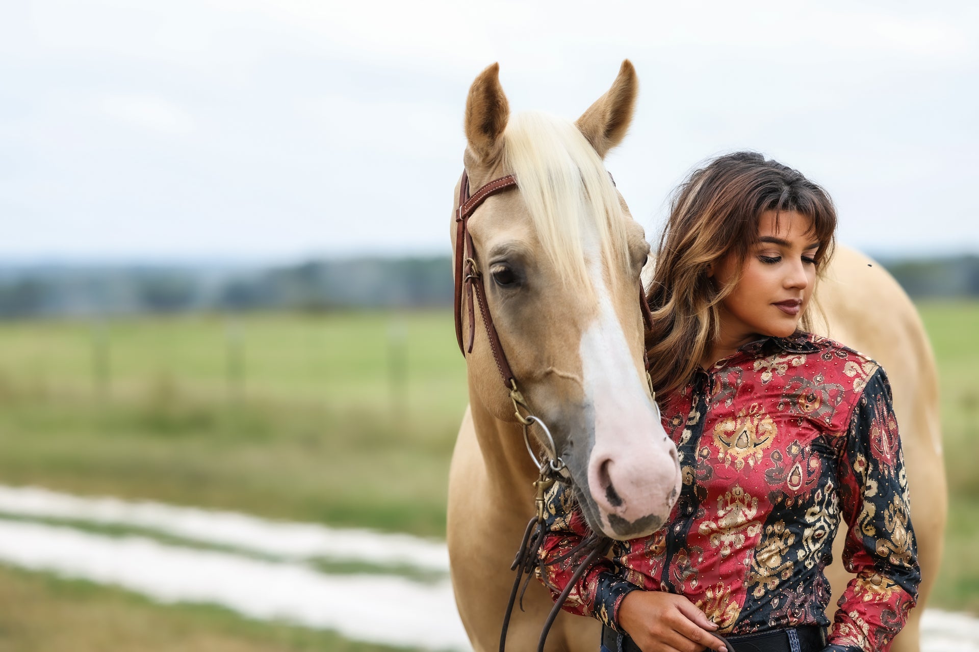 A model displaying our red and black velvet shirt with a horse.