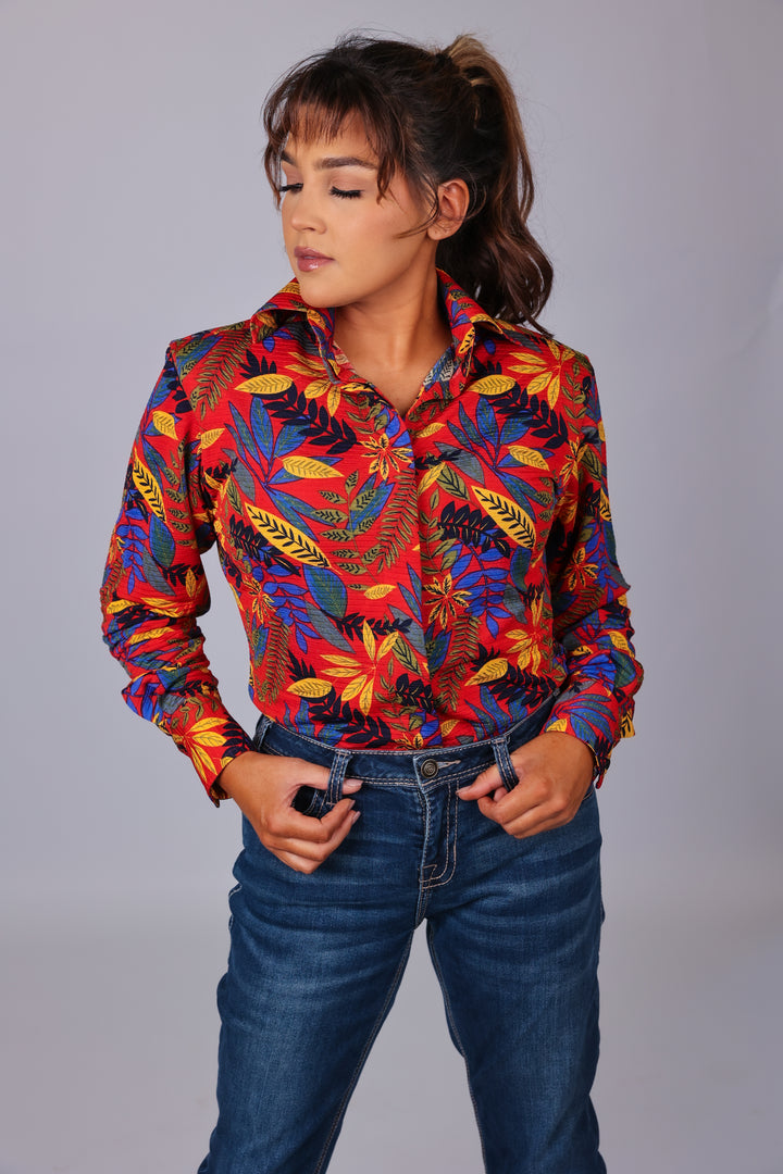 Model posing in jungle red shirt from the Romina collection by Kultured Rider in front of a studio backdrop.